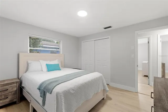 a bedroom with a bed and a painting