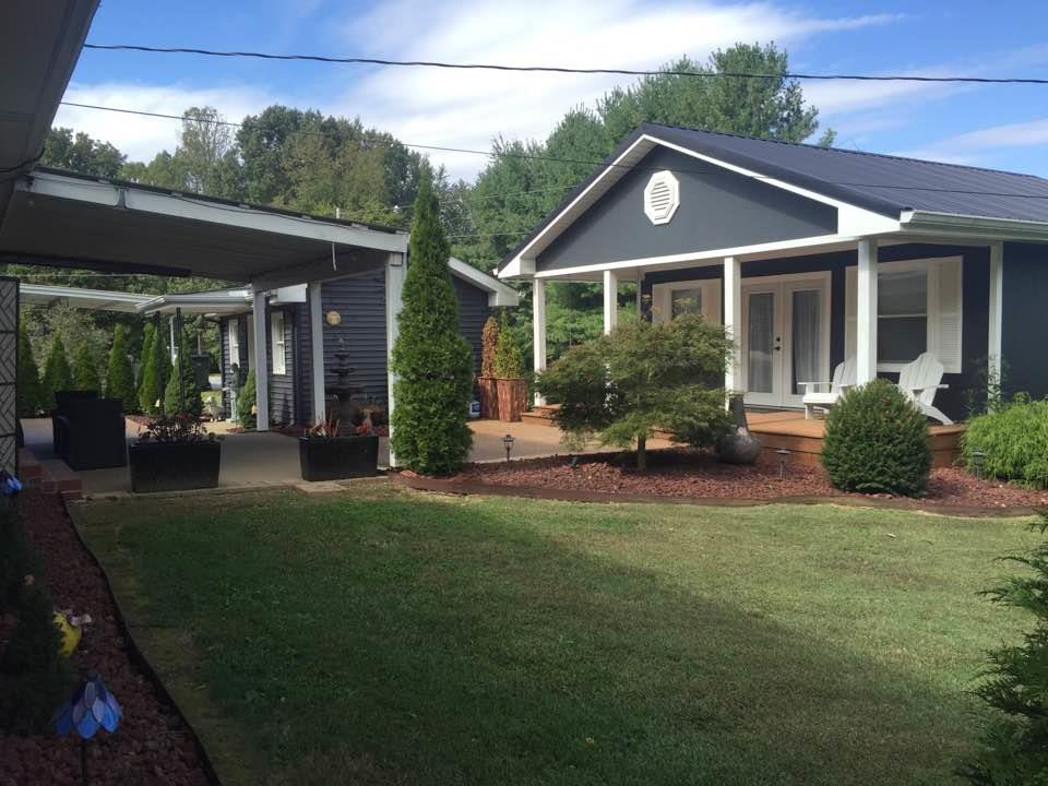 8026 Cedar Grove Road Cross Plains, TN 37049 - Photo 1 of 30 a front view of a house with garden