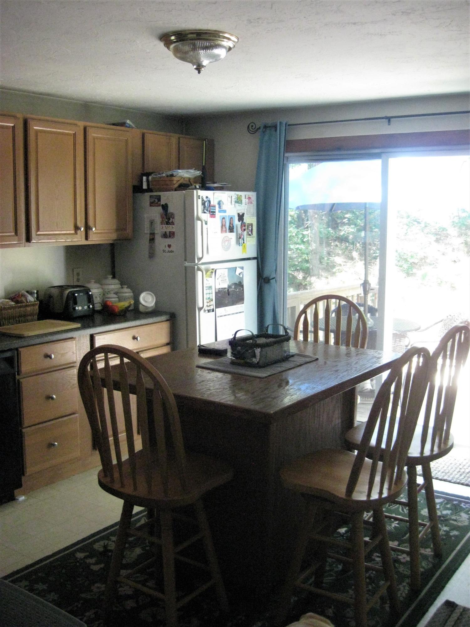 46-a B Standish Road Sagamore Beach, MA 02562 - Photo 22 of 31 a kitchen with stainless steel appliances granite countertop a table chairs sink and cabinets