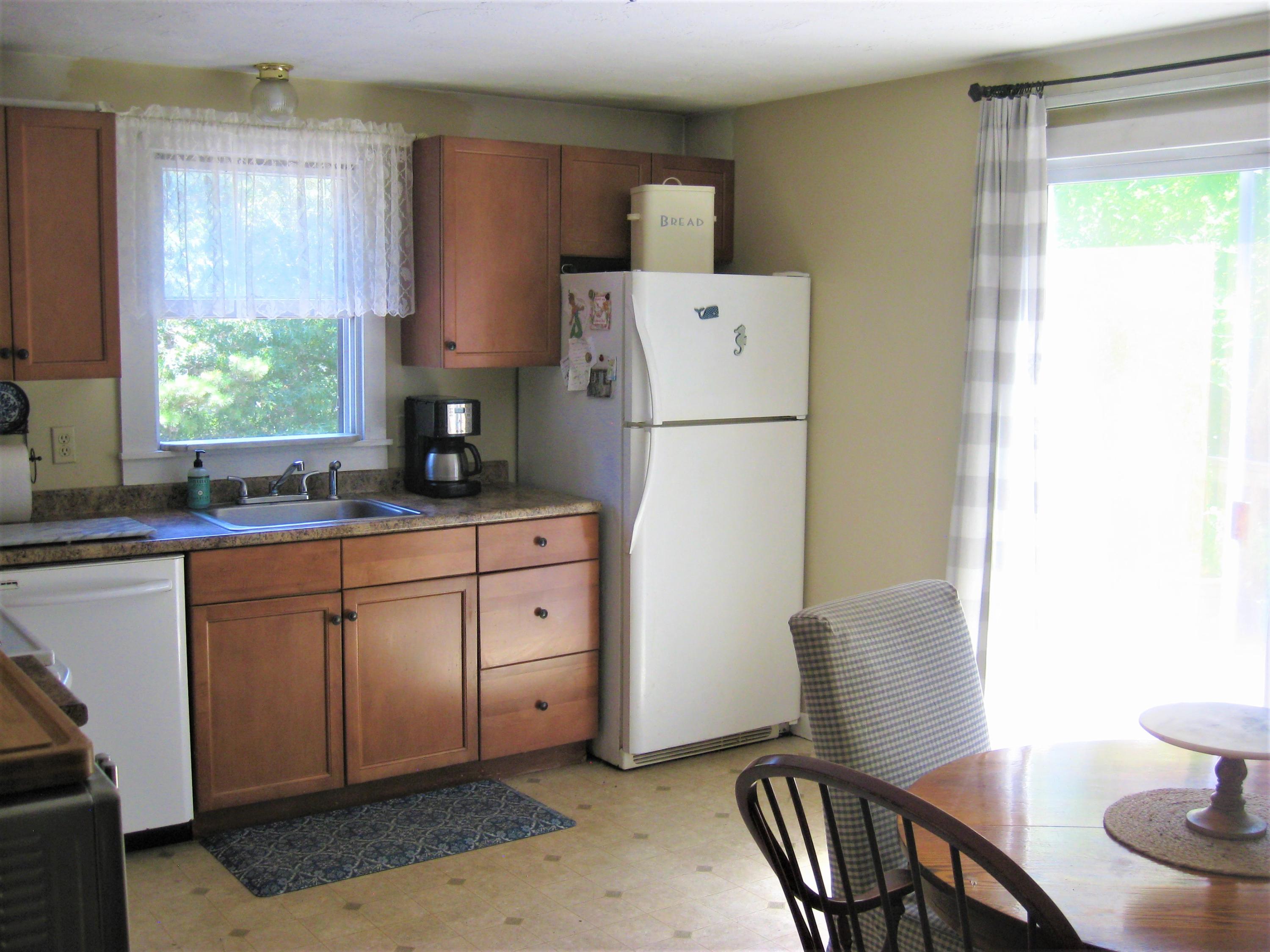 46-a B Standish Road Sagamore Beach, MA 02562 - Photo 9 of 31 a kitchen with sink a refrigerator and wooden cabinets