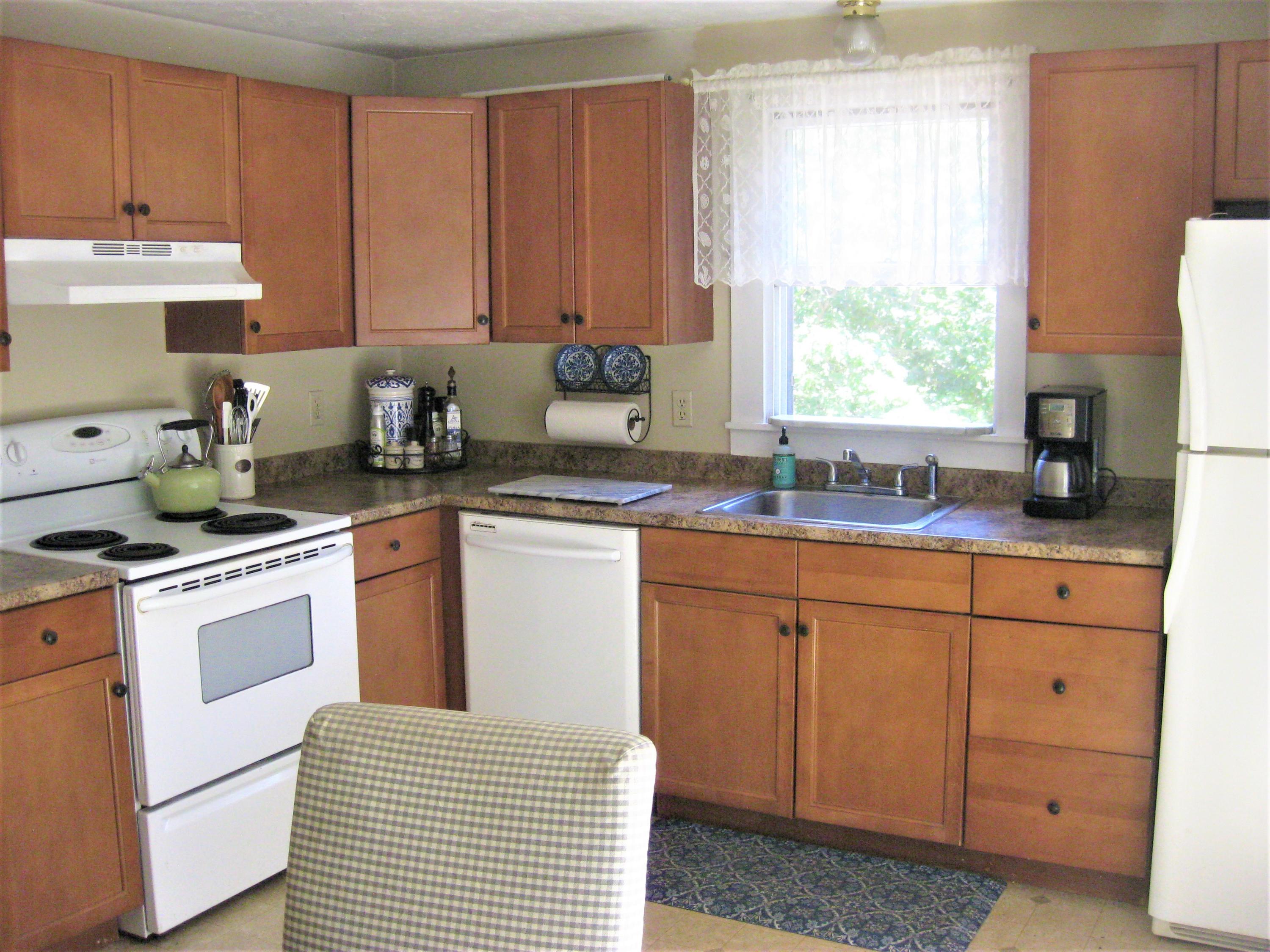 46-a B Standish Road Sagamore Beach, MA 02562 - Photo 10 of 31 a kitchen with granite countertop white cabinets sink and white appliances