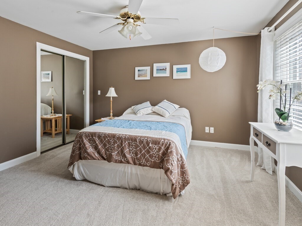 9 Santom Street Auburn, MA 01501 - Photo 26 of 42 a bedroom with a bed and a chandelier