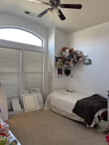 a bedroom with a bed and a chandelier