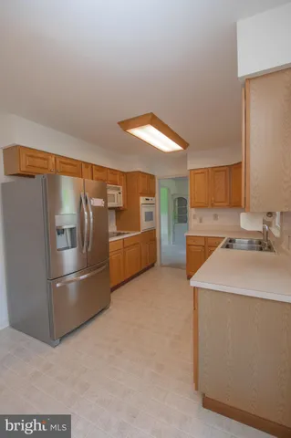 a kitchen with stainless steel appliances a sink and a refrigerator