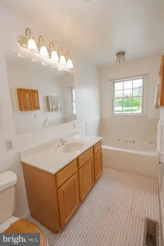 a spacious bathroom with a sink a large mirror and a bathtub