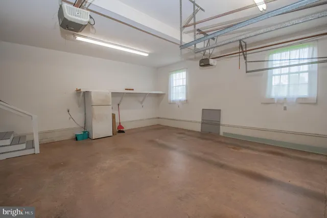 a view of a room with window and a ceiling fan