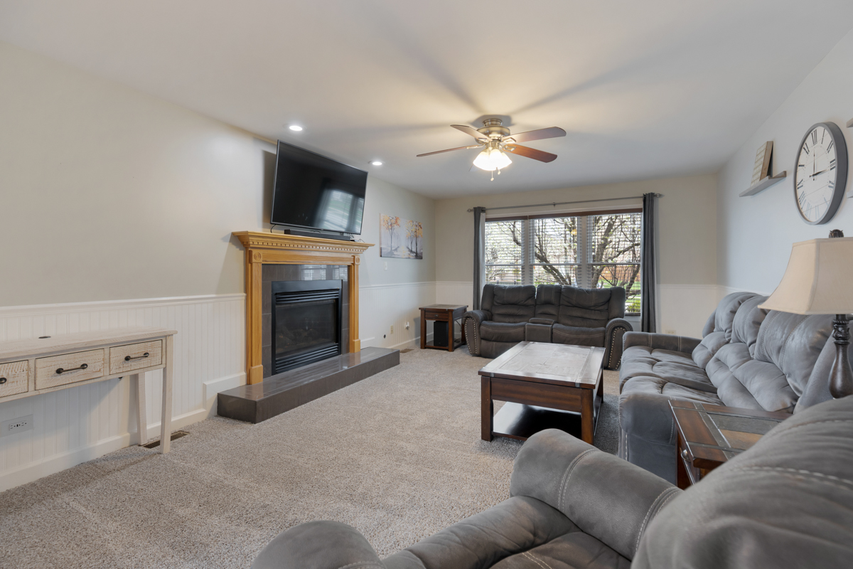 24854 Buttercup Lane Manhattan, IL 60442 - Photo 17 of 36 a living room with furniture and a fireplace