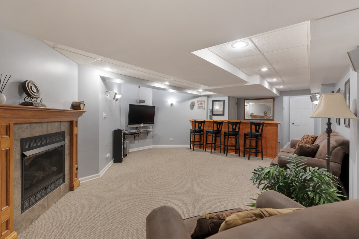 24854 Buttercup Lane Manhattan, IL 60442 - Photo 27 of 36 a living room with furniture and a flat screen tv