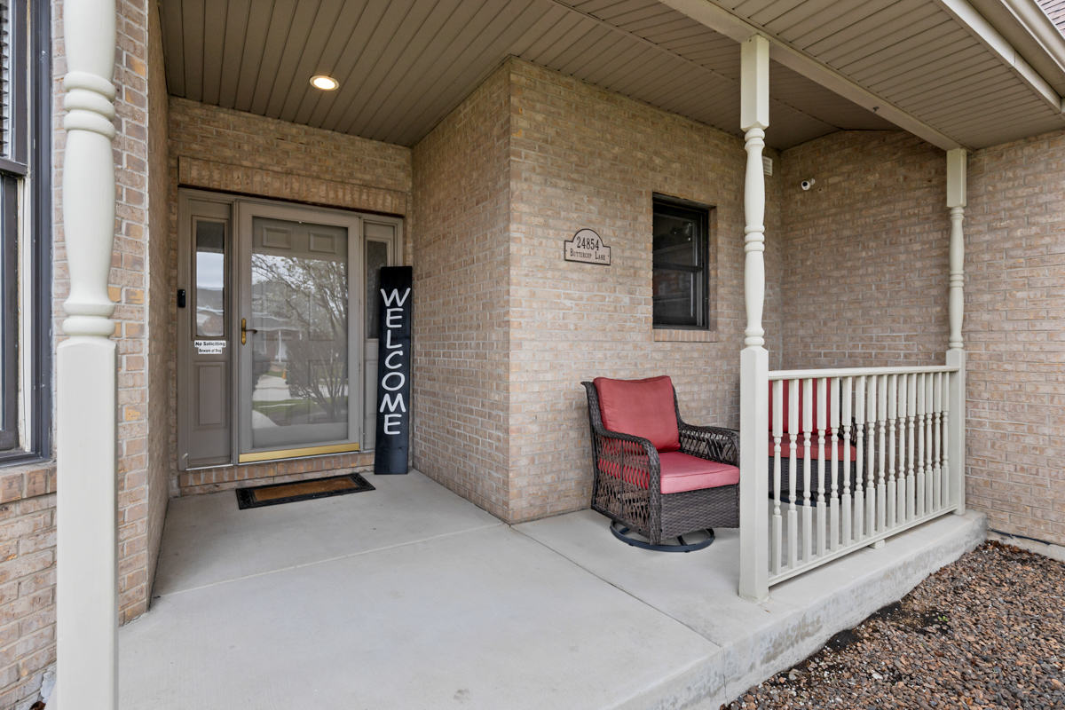 24854 Buttercup Lane Manhattan, IL 60442 - Photo 3 of 36 a view of a porch with a door and wooden floor