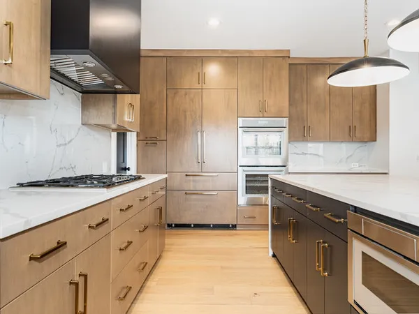 a kitchen with granite countertop white cabinets and white appliances