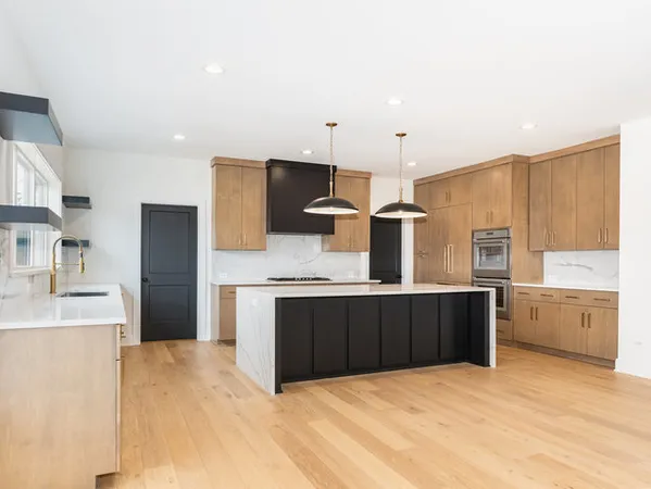 a kitchen with stainless steel appliances a refrigerator and a stove top oven