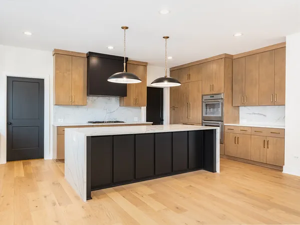 a kitchen with a sink a counter space appliances and cabinets