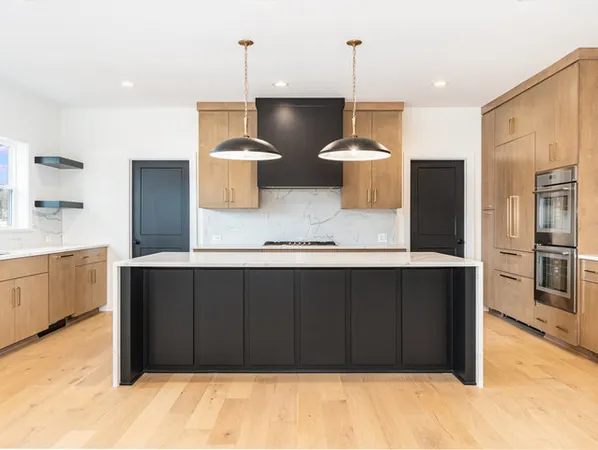 a large kitchen with a wooden floor and stainless steel appliances