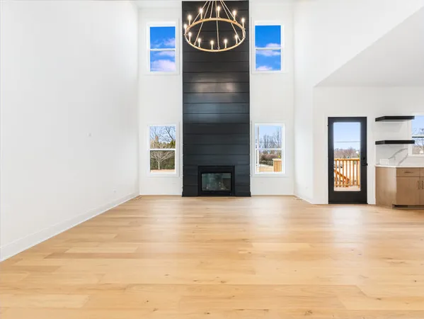 a view of an empty room with window and fireplace