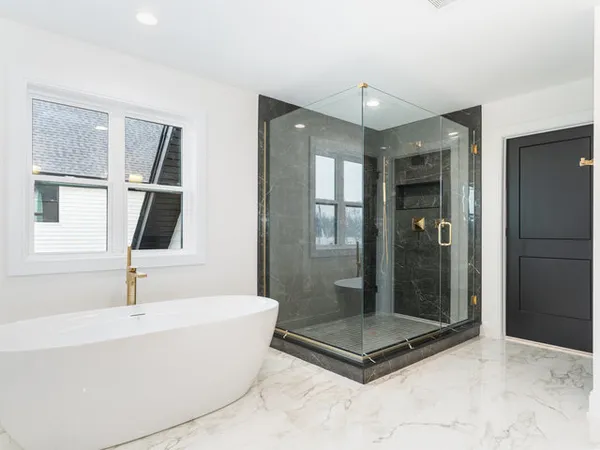 a bathroom with a tub shower and sink