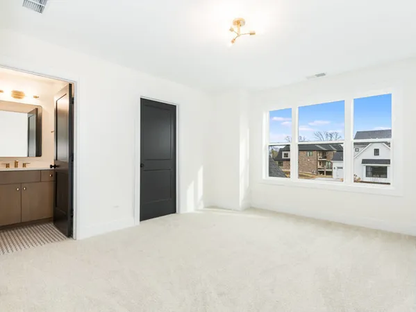 a view of an empty room with a kitchen
