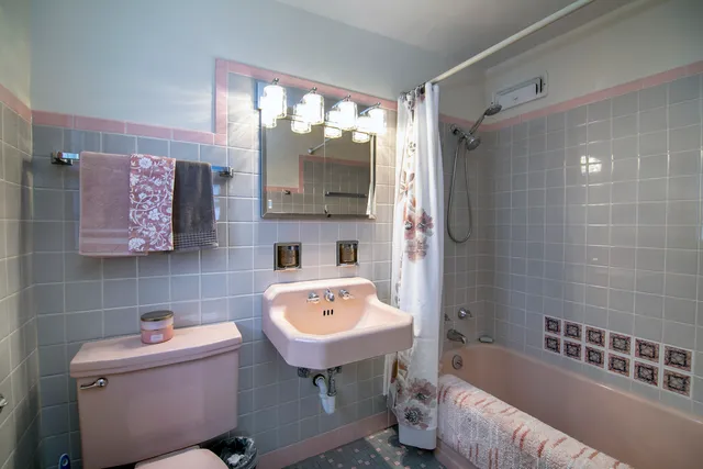 a bathroom with a sink mirror bathtub and toilet