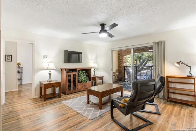 a living room with furniture a fireplace and a window