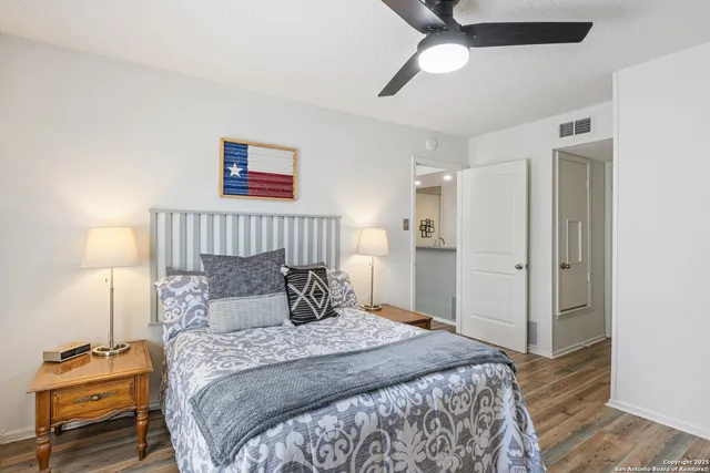 a bedroom with a bed and a lamp