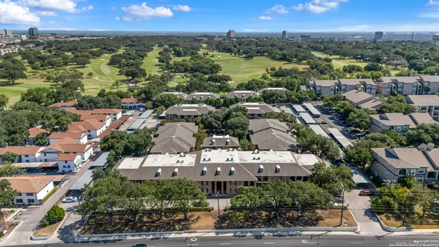 an aerial view of residential houses with outdoor space and street view