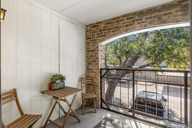 a view of a balcony with furniture