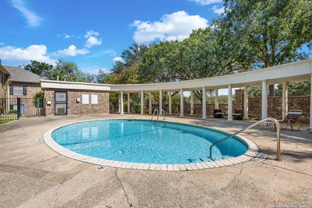 a view of a house with swimming pool and porch