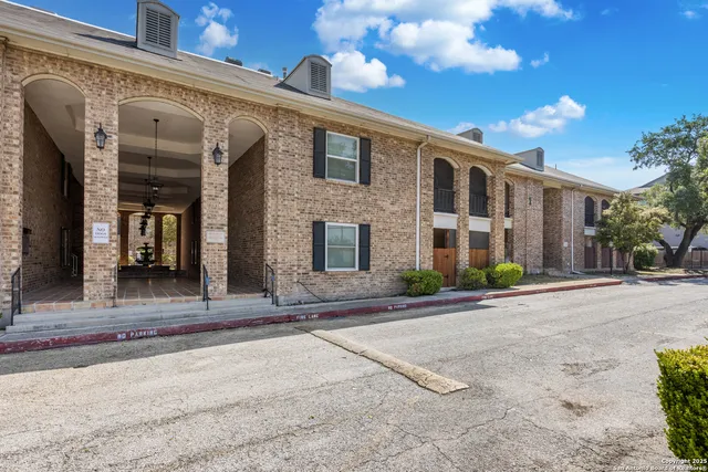 a front view of a building with a yard