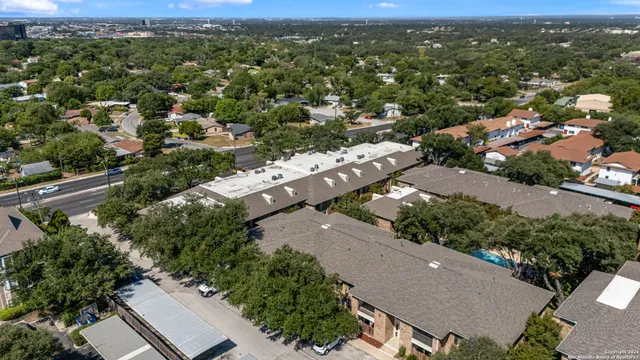 an aerial view of residential houses with outdoor space