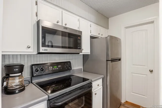 a kitchen with a stove and a microwave