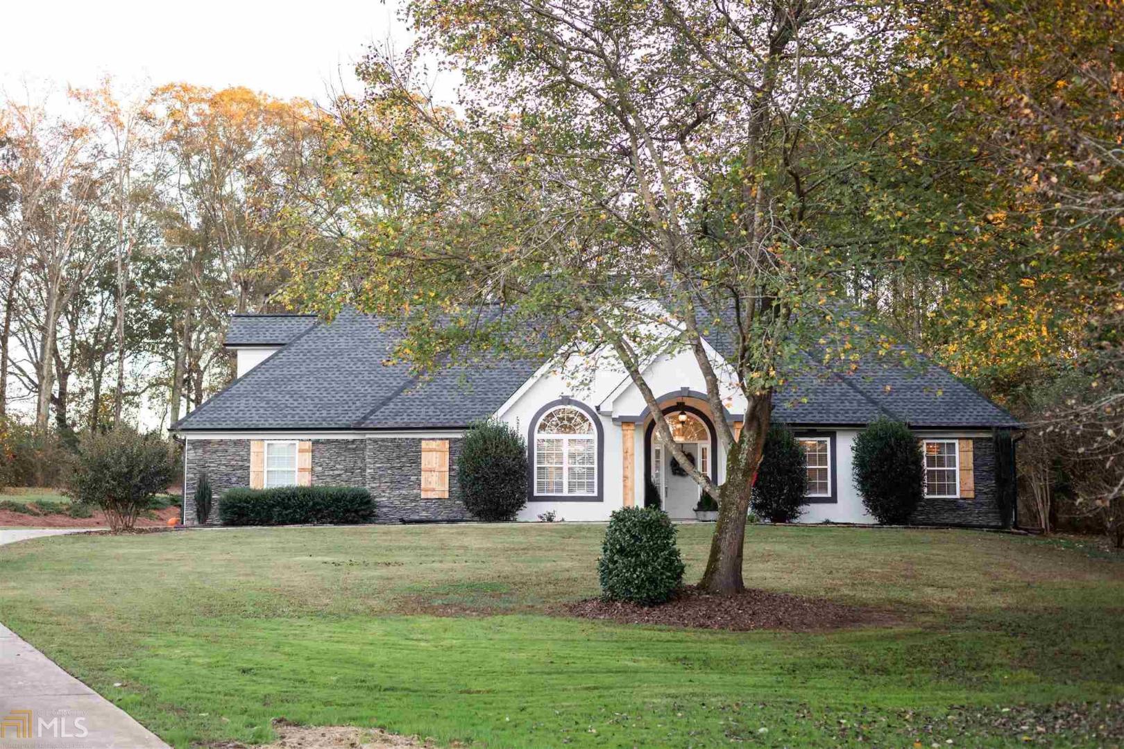 3761 Dixie Road Covington, GA 30014 - Photo 1 of 1 a front view of a house with a garden and trees