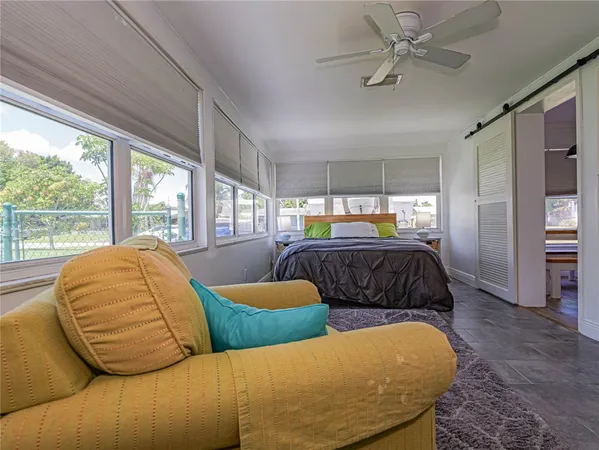 a bedroom with furniture and window