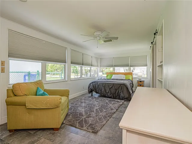 a bedroom with furniture and a window