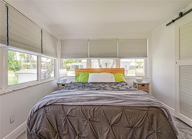a bed sitting in a bedroom next to a window