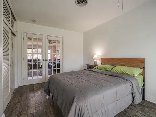a bedroom with a bed and glass door
