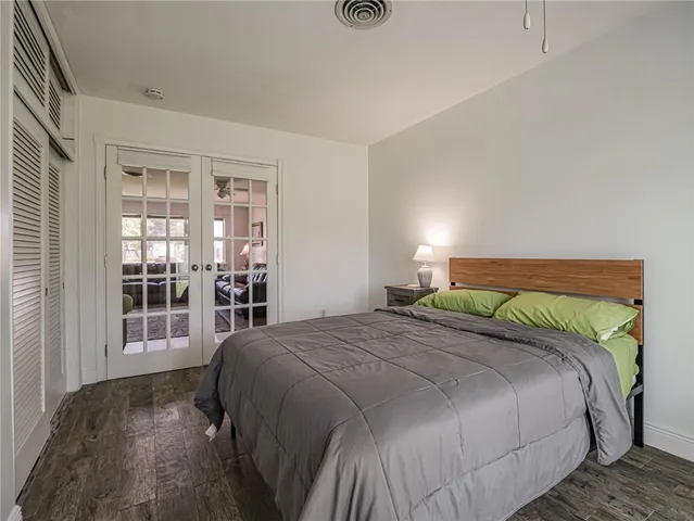 a bedroom with a bed and glass door