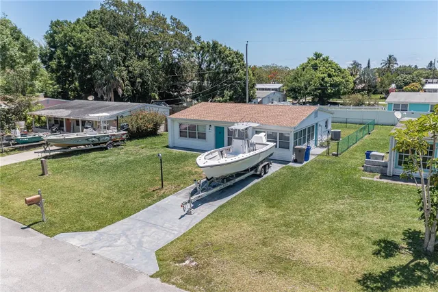 an aerial view of a house with swimming pool garden and patio