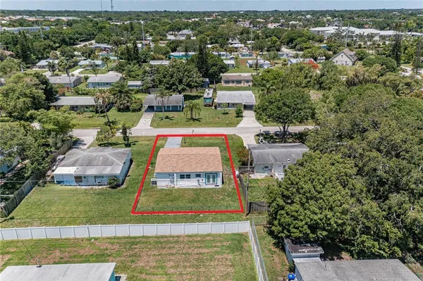 an aerial view of a house with a yard basket ball court and outdoor seating