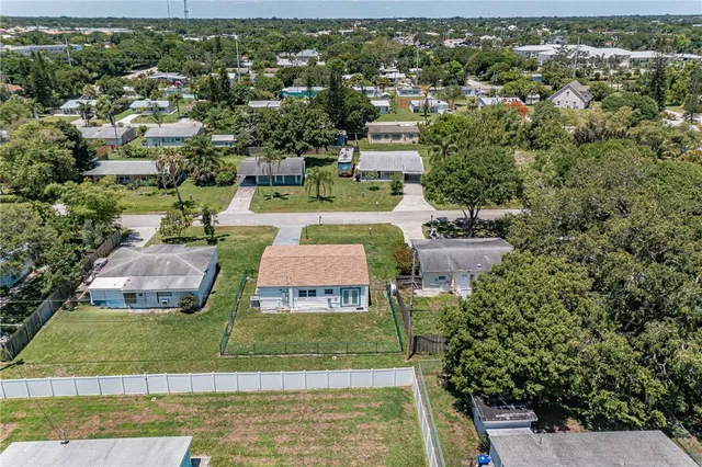 an aerial view of a house with yard swimming pool outdoor seating and yard