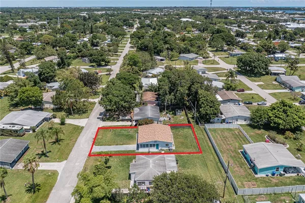an aerial view of residential houses with yard