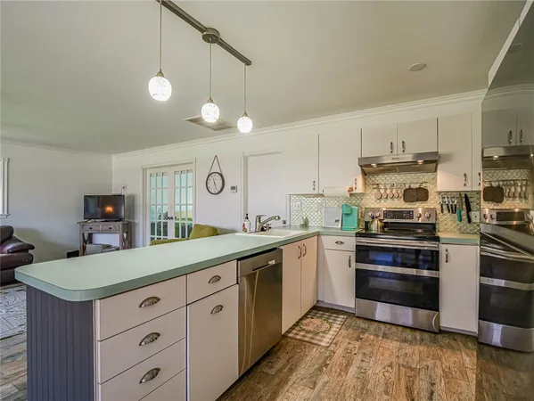 a kitchen with a white cabinets and stainless steel appliances