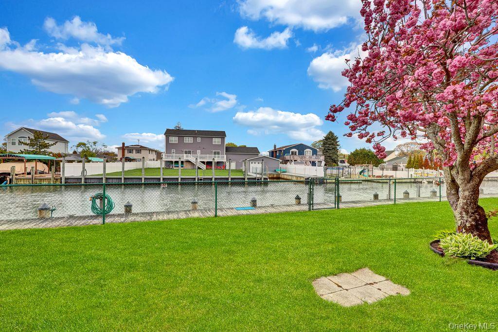 311 Mariners Way Copiague, NY 11726 - Photo 16 of 21 a swimming pool with outdoor seating and yard