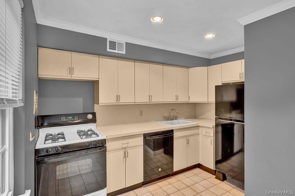 311 Mariners Way Copiague, NY 11726 - Photo 8 of 21 a kitchen with a stove a sink and a refrigerator