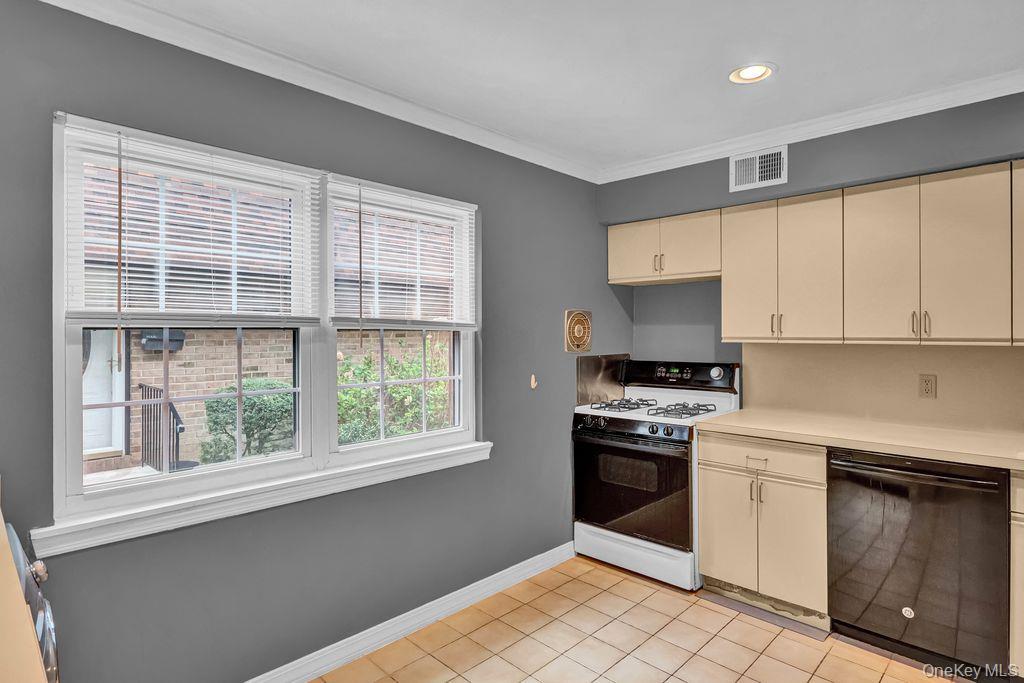 311 Mariners Way Copiague, NY 11726 - Photo 9 of 21 a kitchen with a stove a sink and a window