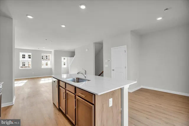 a kitchen with stainless steel appliances granite countertop a sink stove and microwave