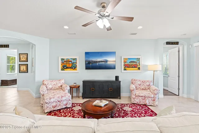 a living room with furniture kitchen view and a large window