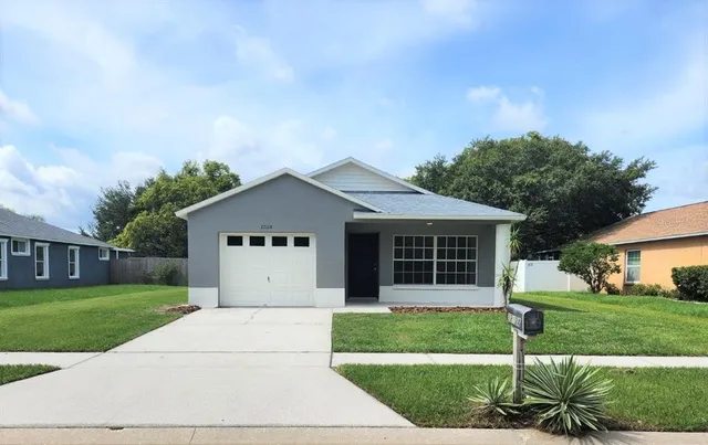 a view of house with a yard and garden