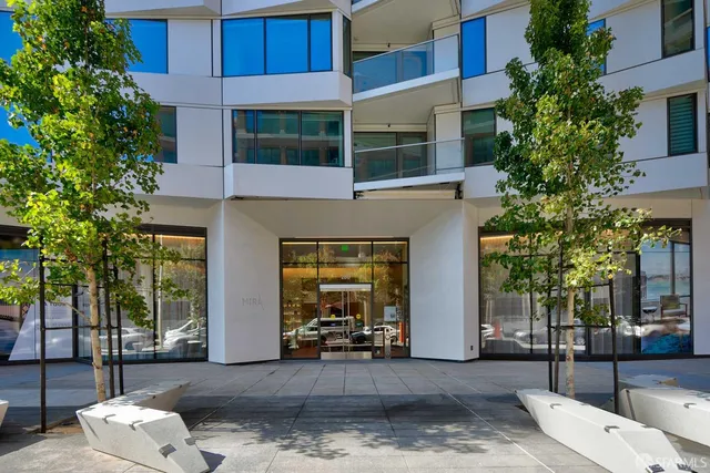 a living room with furniture and large windows
