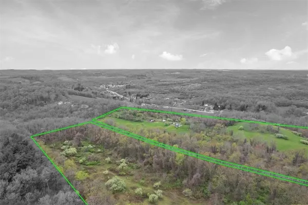 a view of a field with an ocean