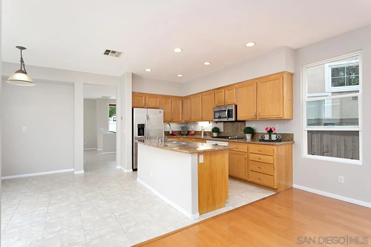 12253 Pepper Tree Lane Poway, CA 92064 - Photo 11 of 39 a kitchen with stainless steel appliances granite countertop a refrigerator and a stove top oven