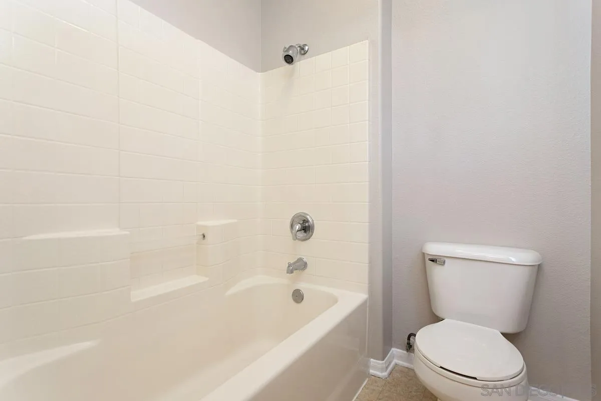 12253 Pepper Tree Lane Poway, CA 92064 - Photo 31 of 39 a white toilet sitting next to a bath tub